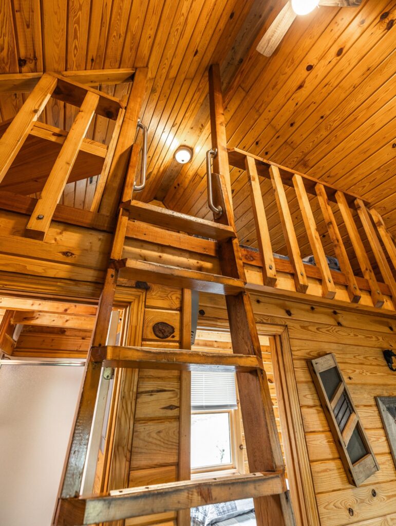 Living area and ladder lofts inside a Country Cabin