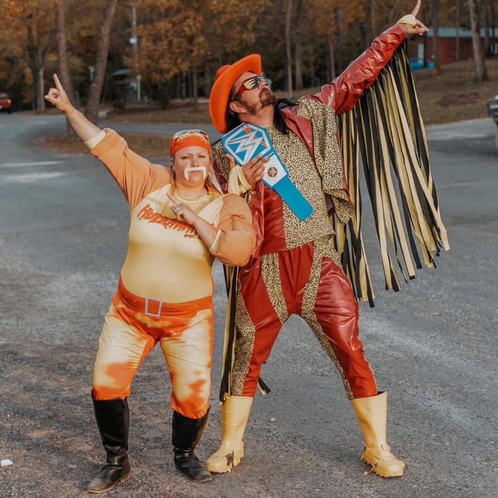 Couple dressed as pro wrestlers posing during the costume contest