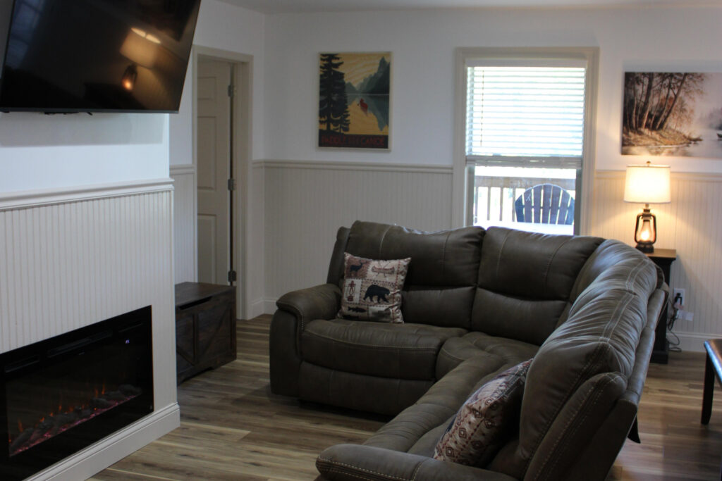 Lookout Lodge living room with sectional sofa and electric fireplace