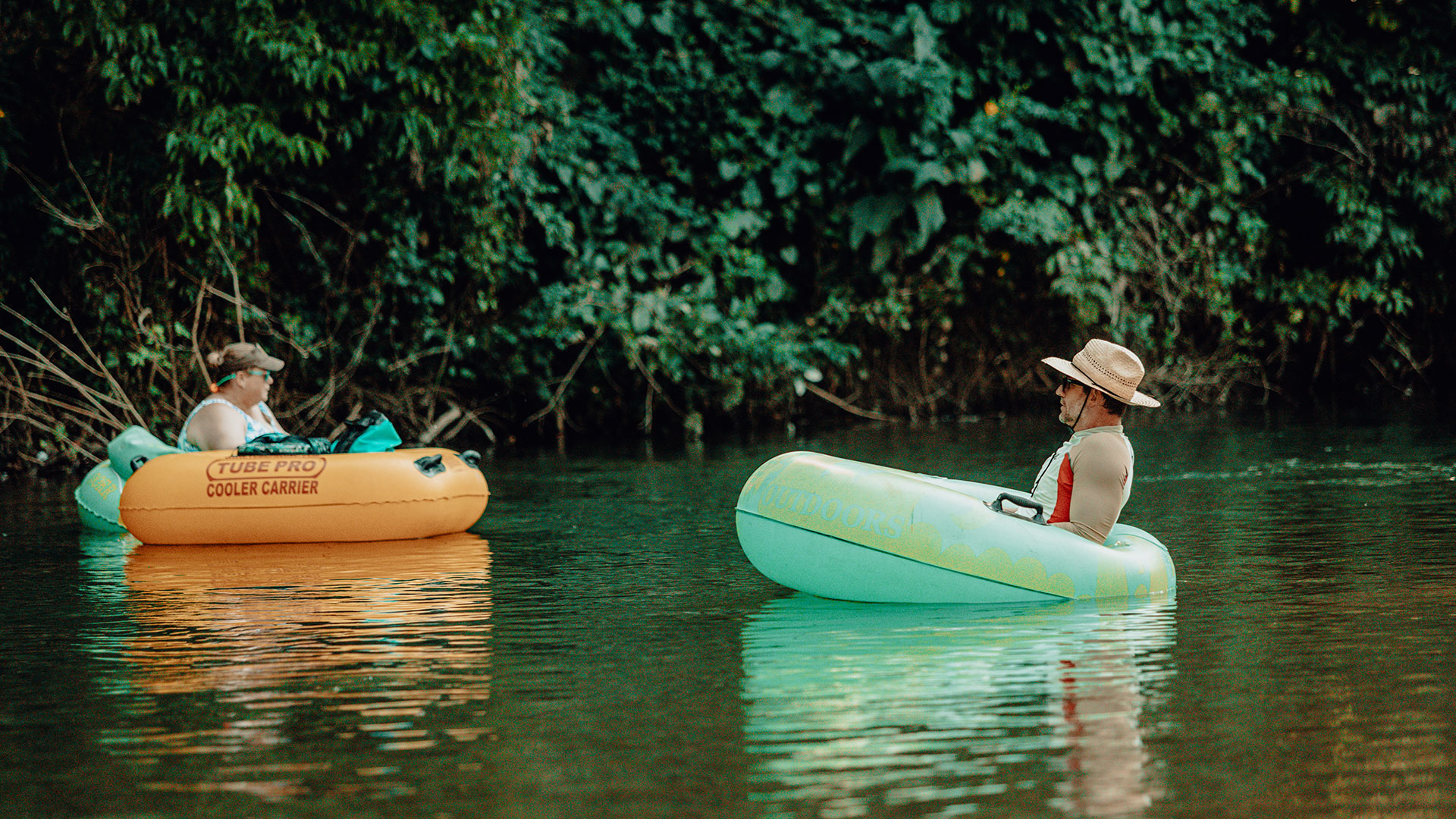 People floating down the river on inner tubes at Ozark Outdoors Resort